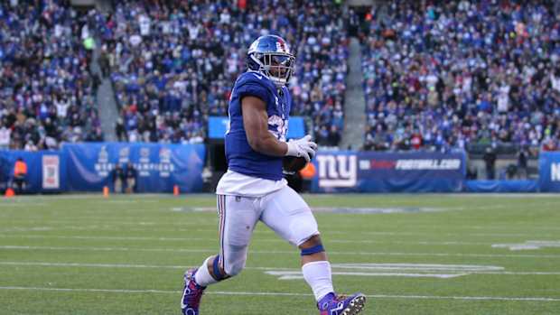 Dec 15, 2019; East Rutherford, NJ, USA; New York Giants running back Saquon Barkley (26) runs for a touchdown against the Miami Dolphins during the third quarter at MetLife Stadium.